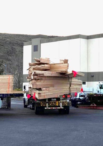 A truck with many wooden boards on the back of it.